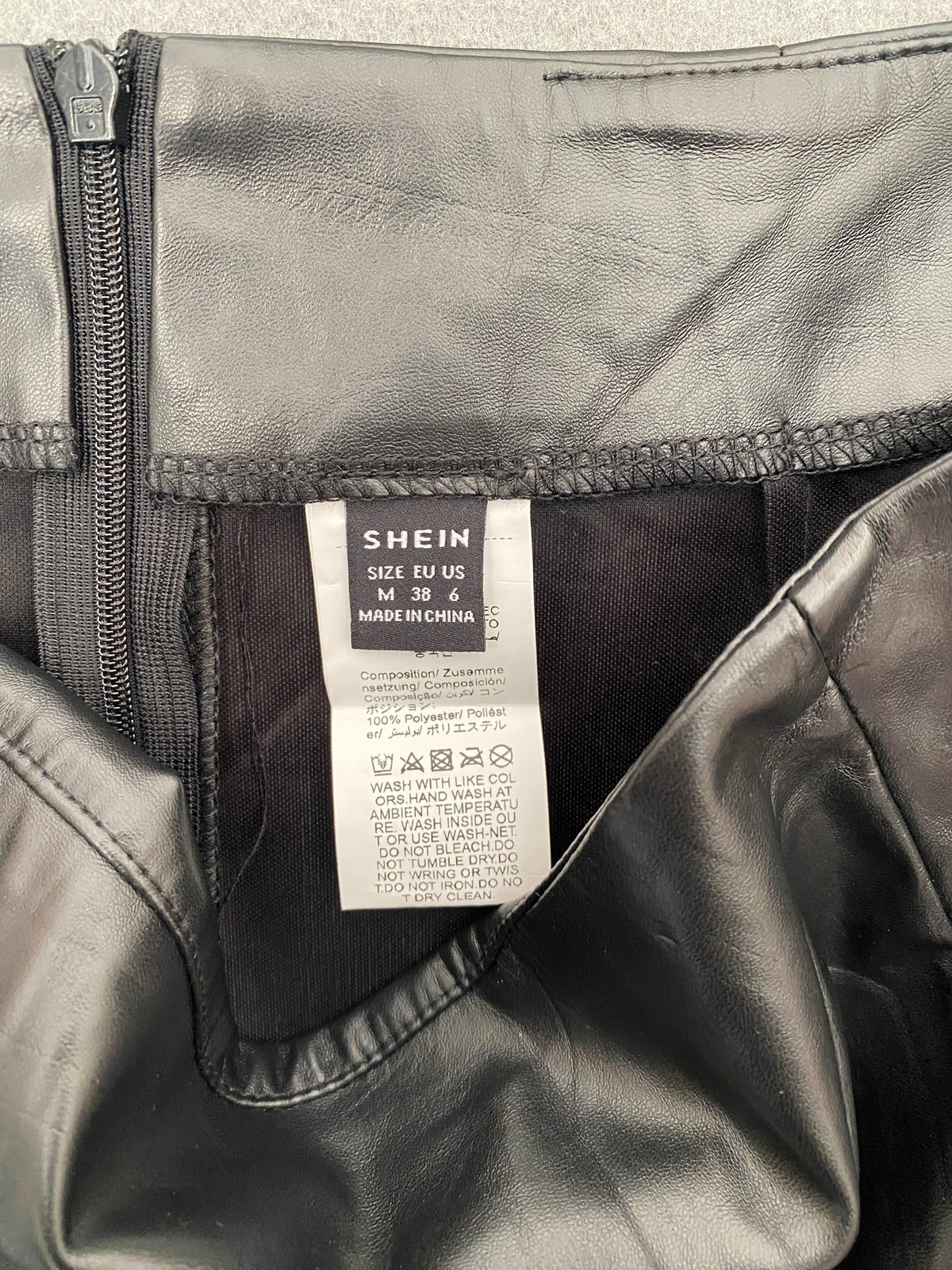 Mini-jupe en simili cuir noire à fente