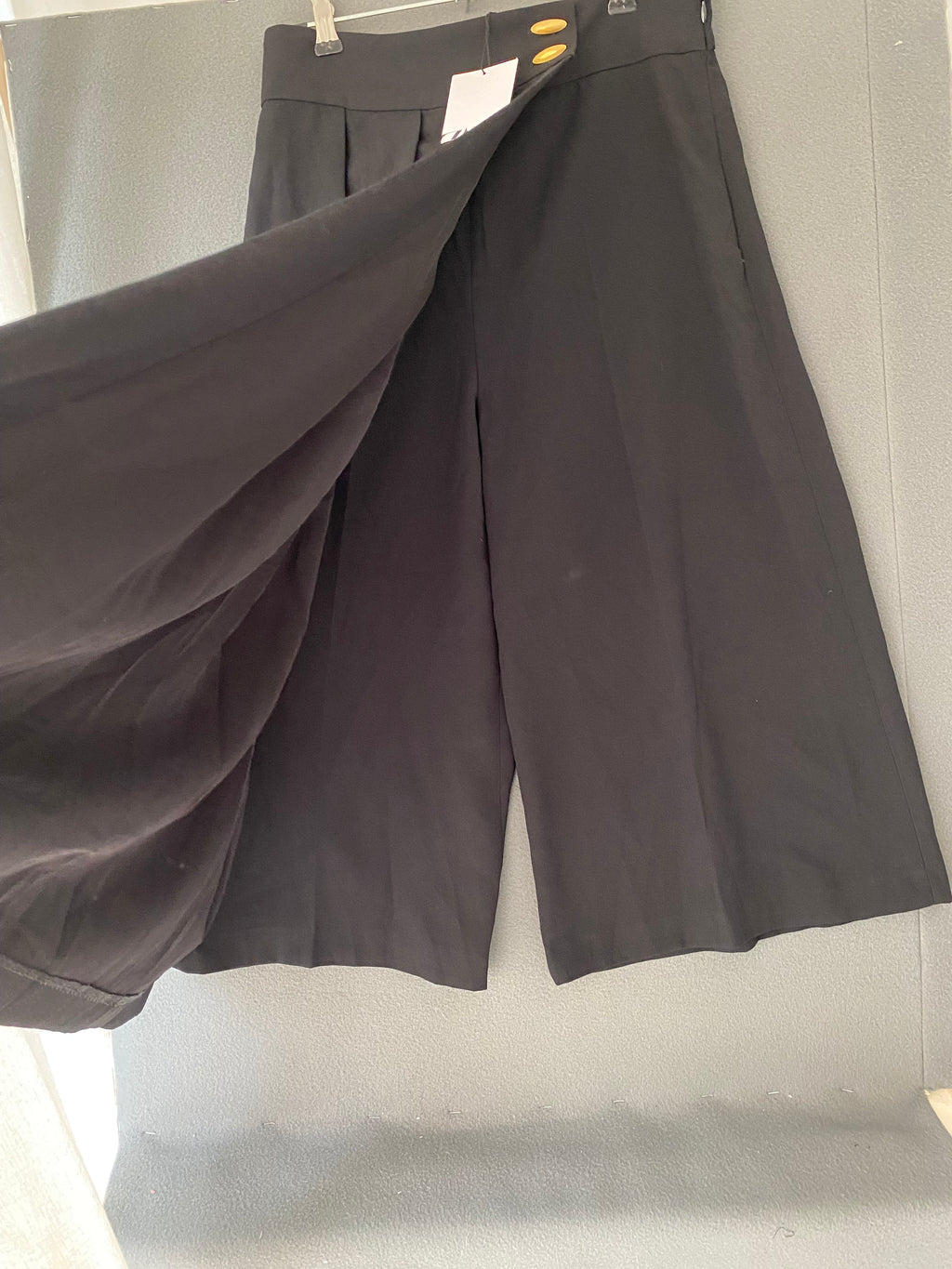 Jupe short midi plissée asymétrique noire à boutons dorés